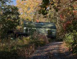 A difficult-to-reach site put a lot of buyers off, but the current homeowners saw a lot of potential in the site's views and historic barn.