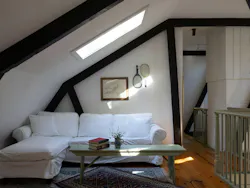 As seen in the loft, the home's original trusses and roofline were preserved during the remodel.