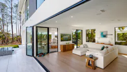 Sliding glass doors open the home to the outside while also prioritizing the site's views.