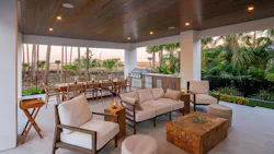 The home features numerous outdoor areas, including this outdoor dining and cooking area.