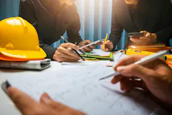 photo of collaboration around a construction set at a table
