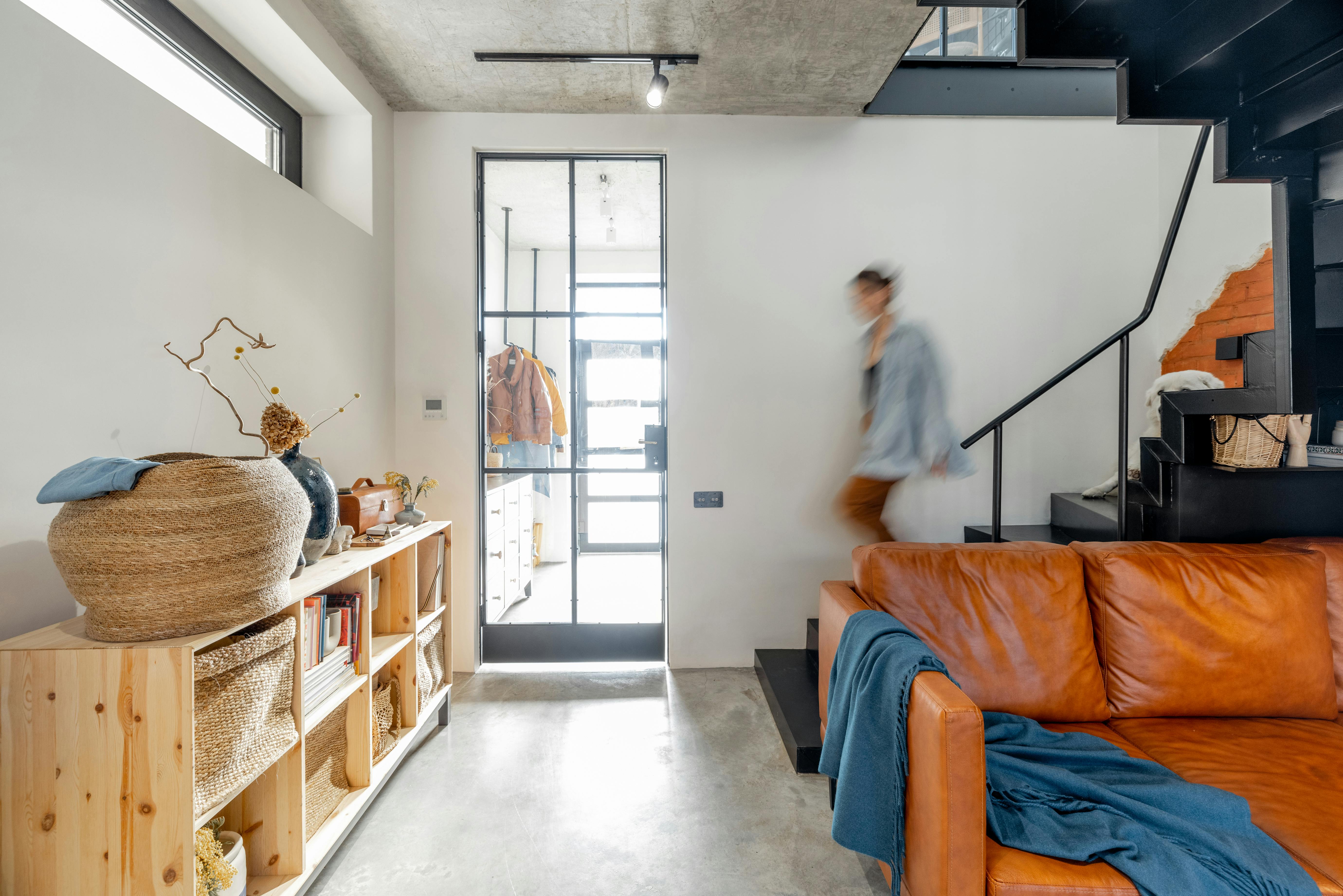 stylish living room interior with a woman walking (blurred)