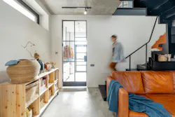 stylish living room interior with a woman walking (blurred)