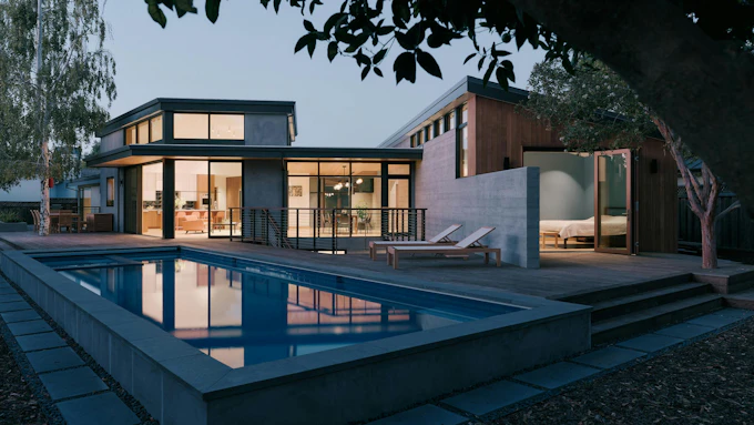 Rear elevation of a Los Altos Calif home showing a courtyard and pool