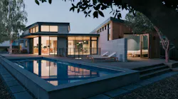 Rear elevation of a Los Altos Calif home showing a courtyard and pool