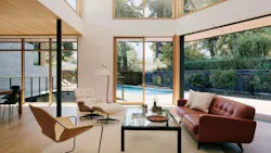 Multifold doors open the great room to the courtyard and pool, and clerestory windows bring in light from above. Photo: Joe Fletcher