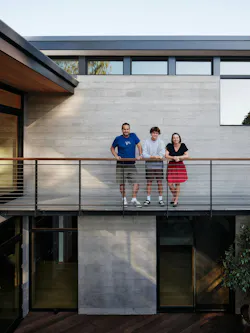 Jason, Clotilde and their son at home. Photo: Joe Fletcher