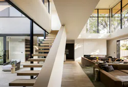 A double-height great room looks out to the home's preserved redwood tree.