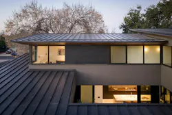 A 1,000-square-foot cap on the home's second floor helped inform the unique shape of the roof.