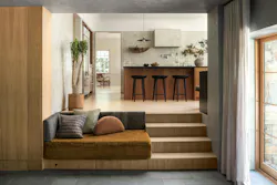 Rather than hide two different floor heights, the design team chose to highlight the two elevations by opening up the doorway between the two rooms and adding integrated bench seating.